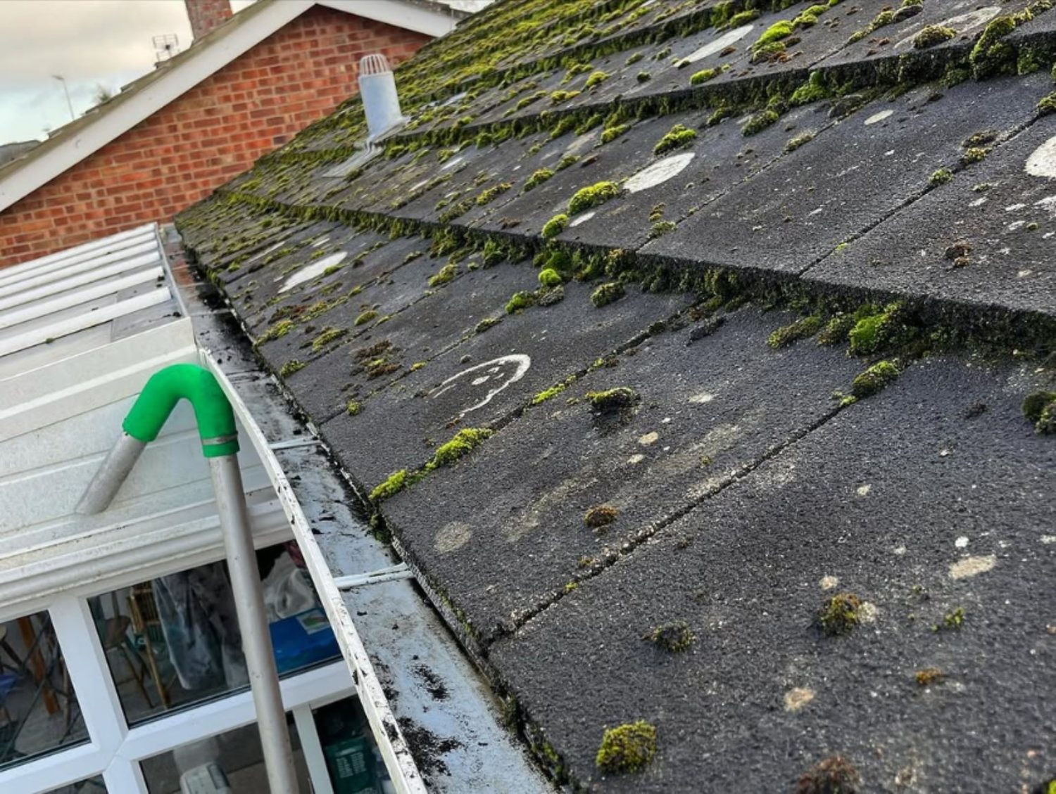 Gutter clearing with vacuum equipment removing debris