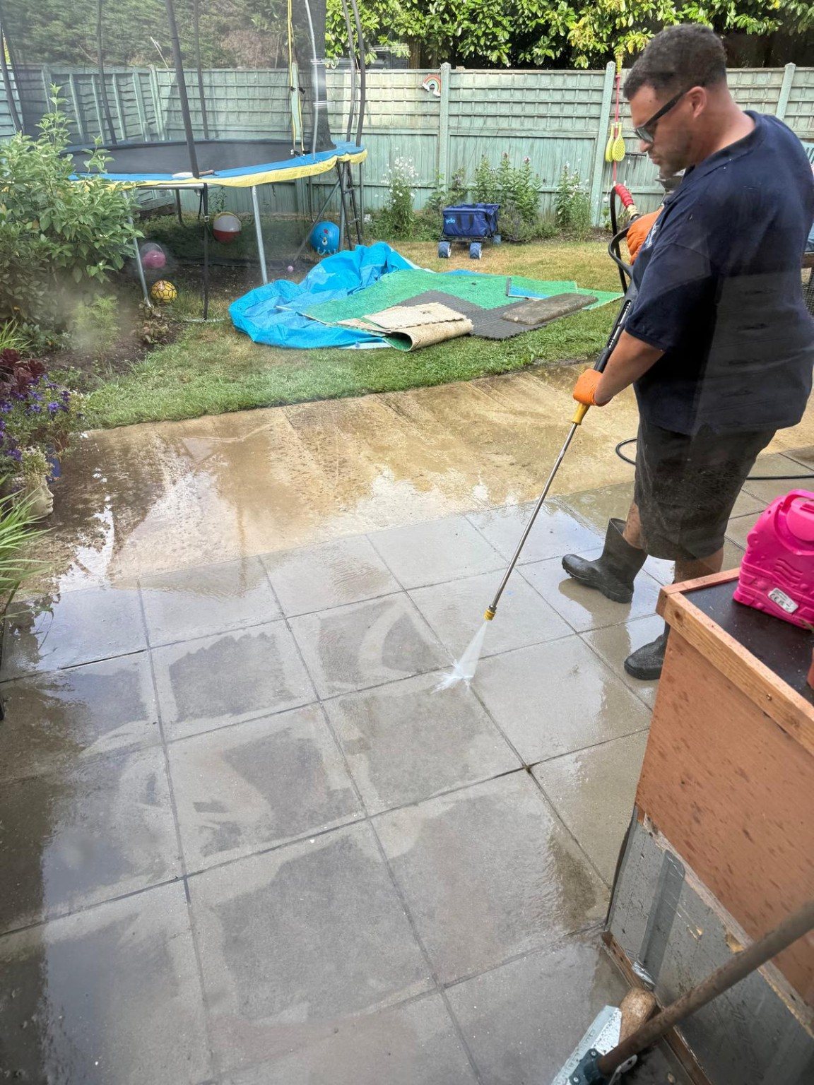 Pressure washing a patio in progress